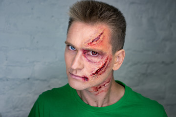 Professional make-up of young man with horrible scars