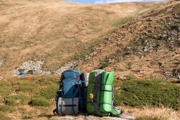 Backpack in the mountains landscape. Trekking equipment.