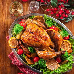 Baked or roasted whole chicken on Christmas table