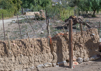 Portion of an old kraal wall constructed from mud and stone image in landscape format with copy space