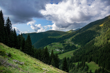 Fototapeta na wymiar Mountain valley in Italy with clouds in the sky