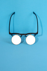 Sunglasses with double glass on a blue background