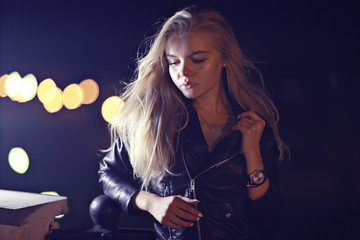 beautiful girl posing in the night city / model adult girl posing in the evening in the city, outdoor at night
