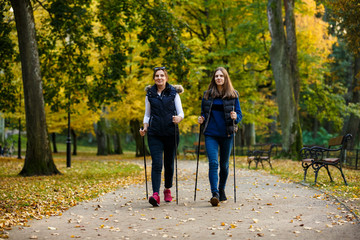 Nordic walking - active people working out in park