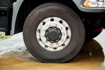 Obraz na płótnie Canvas Closeup view of a rubber tire on a truck.Truck Wheels and Tires Closeup Photo. Heavy Duty Truck Wheels.