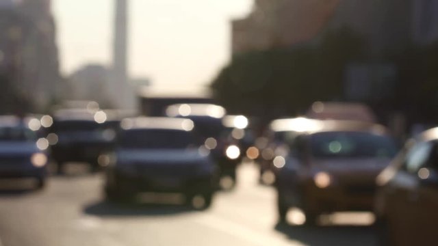Blurred video shot of urban traffic during rush hour on town streets at sunset. Real time
