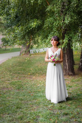 bride in wedding white dress with bouquet