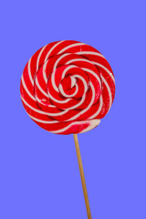 Sweet red lollipop on blue background