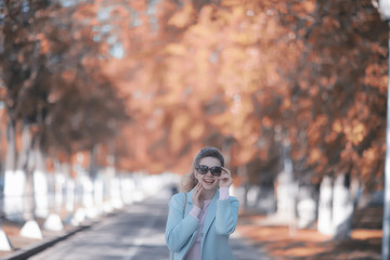 Fototapeta premium walk in autumn park / beautiful girl in autumn park, model female happiness and fun in yellow trees October
