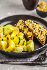 Vegan lunch baked vegetables and sandwich with guacamole.