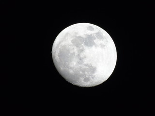 An amazing photography of the full moonlight under a dark sky with some small stars in the background