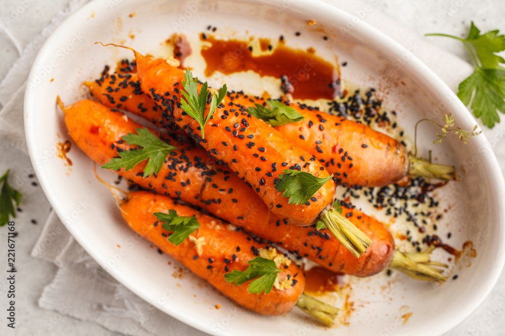 Sticker Whole young carrots baked with Asian sauce and sesame seeds.