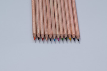 Wooden colorful ordinary pencils  on a white background