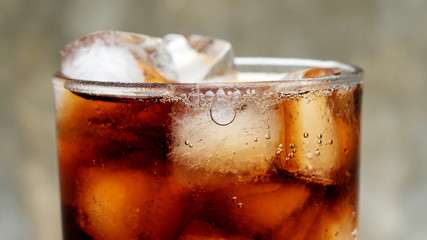 Iced aerated soft drink on a gray background.