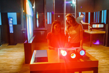Female students making optical experiments confirming the physical law of wave length and...