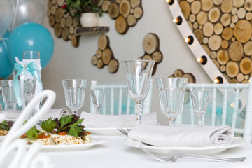 glasses, plates on a festive table, an interior, cutlery,
