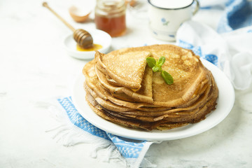 Homemade crepes with honey and butter