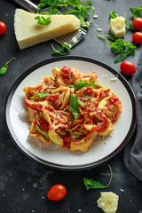 Spinach ricotta Ravioli in tomato sauce with wild rocket and parmesan cheese