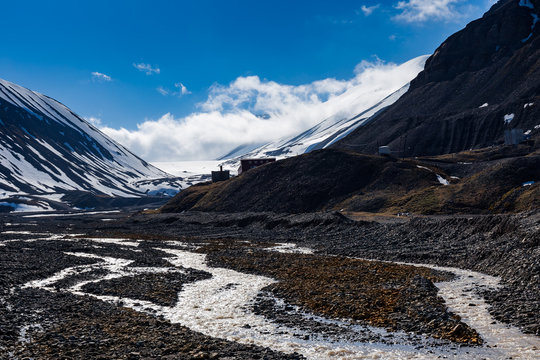 Melting glacier forms a mountain river Longyearbyen