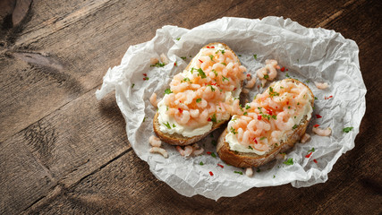 Prawns, shrimp seafood bruschetta with creamy cheese, parsley and chili