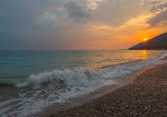 The picturesque sea at sunset. Sunset on the Black Sea with the sun. Georgia, Abkhazia. Colorful sunset with waves.