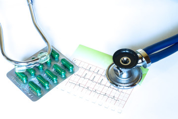 Medical stethoscope and pills with electrocardiogram