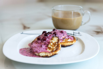 cottage cheese pancakes with berry sauce, pancakes with cowberry, coffee mug