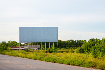 Obraz premium blank billboard on the sideway in the park. image for copy space, advertisement, text and object. white billboard in natural green.