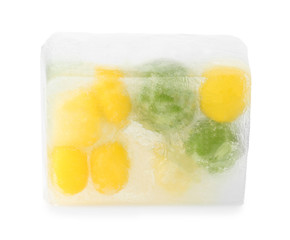 Corn grains and green peas in ice cube on white background. Frozen vegetables