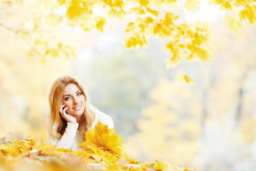 Woman laying in autumn park