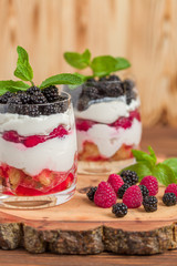 Trifle close up photography with fresh multi layered dessert with dairy and ripe raspberries and...