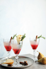 Tasty refreshing pear cocktail with rosemary on table