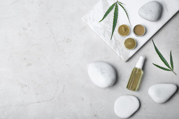 Flat lay composition with hemp lotion and space for text on light background