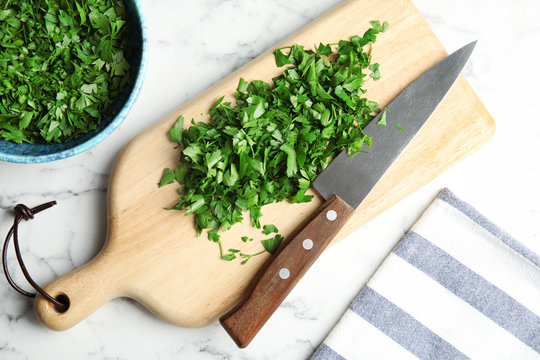 Flat lay composition with fresh green parsley on marble background