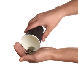 Poor man holding cup with coins on white background, closeup