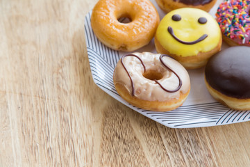 Colorful donuts on dish