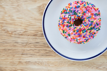 Colorful donuts on dish