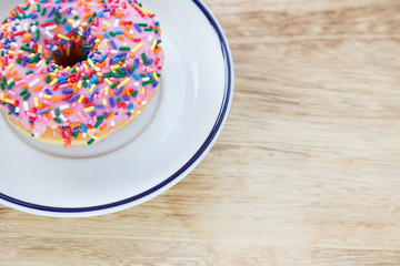 Colorful donuts on dish