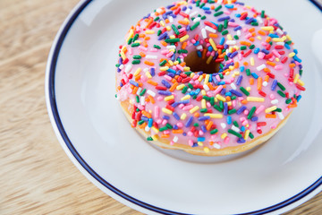 Colorful donuts on dish