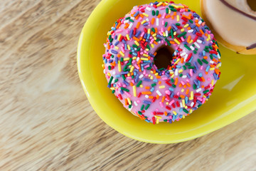 Colorful donuts on dish