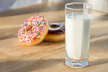 Delicious donuts with cup of milk
