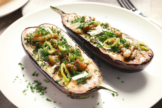 Plate with tasty stuffed eggplants, close up view