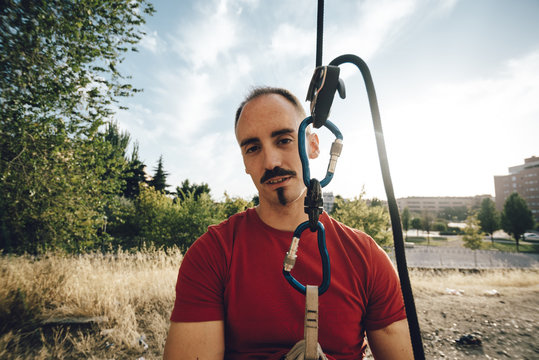 Portrait of aerial dancer testing rope for safety in a wall