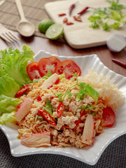 Thai yum salad hot and spicy with pork, krab sticks, vermicelli and vegetables. Yum salad is a Thai local food, Spicy sour and sweet taste. © poravute