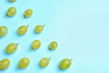 Fresh ripe juicy green grapes on color background, top view. Space for text