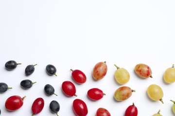 Fresh ripe juicy grapes on white background, top view. Space for text