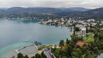 Fototapeta premium Aerial view of Portschach Am Worthersee small town on beautiful lake Worthersee in Austria