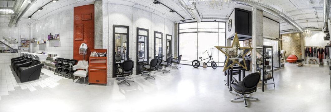 Panoramic view of a industrial look beauty salon. Hair salon and make up store, barber shop and manicure interior business