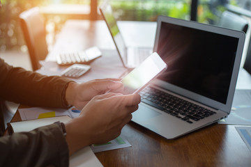 Hands of businessman analyzing charts and graph of tablet computer