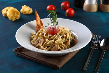 tagliatelle with tomato on a wooden background